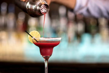 Bartender preparing fruit cocktail.