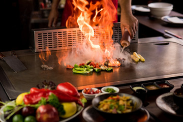 Chef preparing teppanyaki on a hot plate