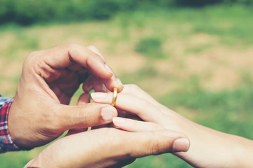 Young hipster couple wearing engagement ring in nature,Sweet and