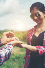 Young hipster couple wearing engagement ring in nature,Sweet and