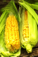 Grains of ripe corn on wooden background