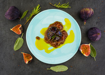 Baked figs with honey and porto with herbs and spices in vanilla sauce. Top view.