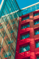 tall building modern type in high-tech style with red walls, square windows and the transparent part