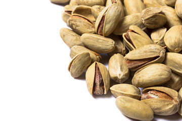 Roasted pistachios on a white background, Macro