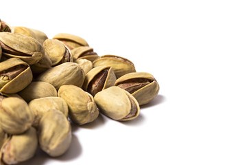 Roasted pistachios on a white background, Macro