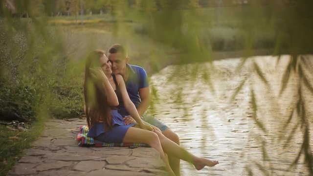 Romantic date. Couple in love on the shore near the water