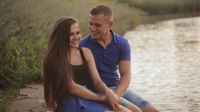Romantic date. Couple in love on the shore near the water