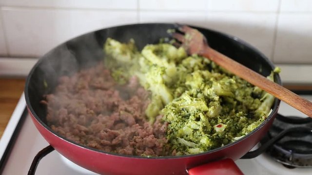 sausage and broccoli in a pan - Italian dish