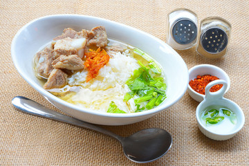 boiled rice with pork rib hot soup on bowl
