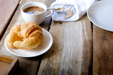 breakfast with croissants, cup of coffee.