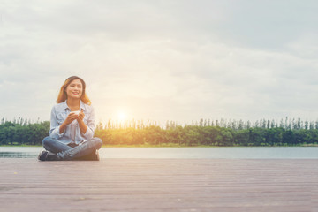 Fototapeta premium young beautiful hipster woman sitting with morning coffee at riv