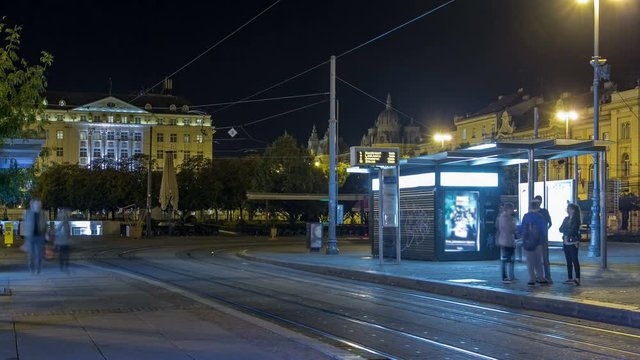 New modern trams of Croatian capital Zagreb night timelapse near railway station. ZAGREB, CROATIA