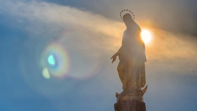 Holy Mary monument with sun behind it on square in front of the Cathedral timelapse in Zagreb, Croatia