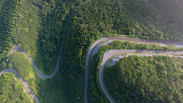 Aerial view of winding road in forest
