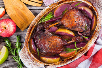 two roasted duck legs grilled  in red wine and apple