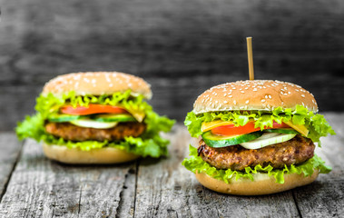 Grilled hamburger, barbecue burger and vegetables in sesame bun