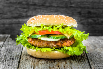Closeup of hamburger bun, beef burger on wooden background