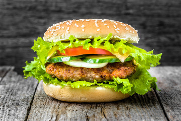 Closeup of beef burger, hamburger bun with meat and vegetables