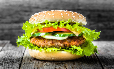 Beef hamburger, close-up, burger bun with grilled meat and vegetables