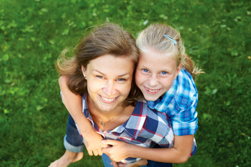 Fototapeta premium Happy family. child and happy parent concept - hugging mother an