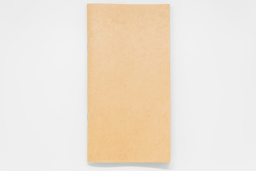 Fototapeta premium Brown plain notebook on white background and selective focus