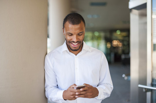 Businessman looking at his cell phone
