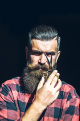 Man hipster with scissors