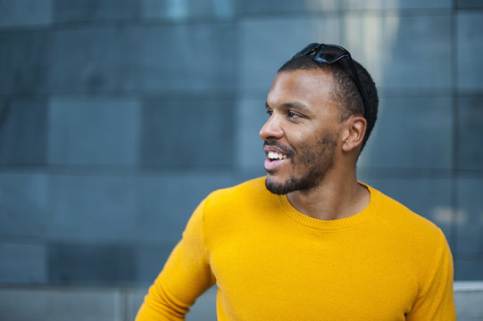 Smiling man wearing yellow pullover