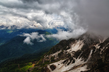 Fototapeta na wymiar Big clouds over the snow-capped mountain peaks,Caucasus