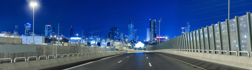 Empty freeway at night And Tel Aviv Skyline in Background