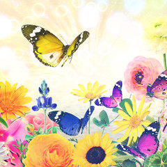 Colorful beautiful flowers and butterflies against magic sun light blurred background with sparkle spots. Summertime nature abstract. Toned colors image