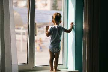Baby boy on window sill