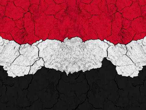 Flag of Yemen on rugged wall full of scratches - metaphor of problem and crisis leading to collapse of country - yemeni civil war between government and rebels