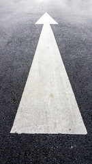Arrows on asphalt road surface. Forward signs on the road