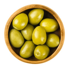 Gordal Reina green olives in a wooden bowl over white. The Queen of all olives. Extra large and very succulent table olives from Andalusia, Spain. Dried ripe fruits of Olea europaea. Macro food photo.