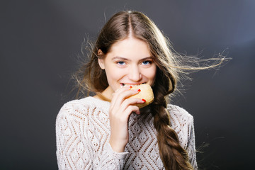 sexy young girl eating bread roll