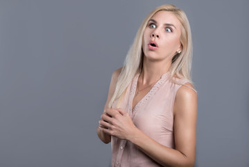Confused and surprised beautiful woman opening mouth