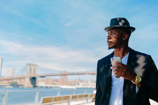 Young fashionable businessman using mobile phone