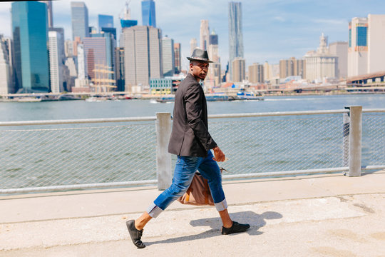 Young Fashionable Businessman Heading To Work . Manhattan Background New York City