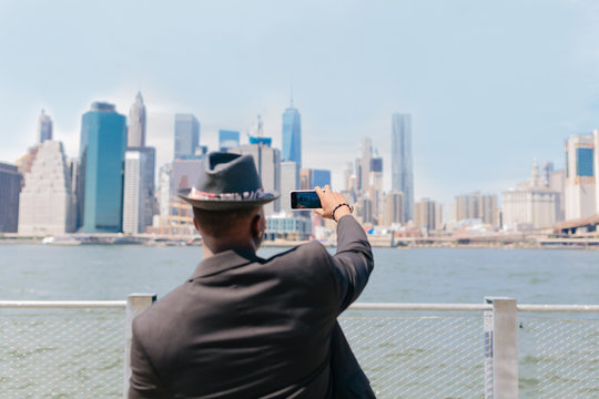 Young Black Guy Taking Picture of the Manhattan Skyline . New York City