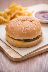 Fototapeta na wymiar Cheese Hamburger with french fries and ketchup