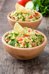 Tabbouleh salad with couscous on rustic wooden table

