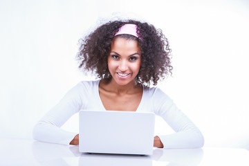 Portrait of a beautiful young black girl with laptop running
