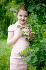 Portrait of beautiful little girl in forest Park