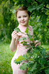 Portrait of beautiful little girl in forest Park