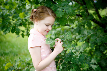 Portrait of beautiful little girl in forest Park