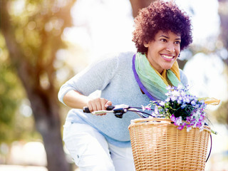 Happy young woman with bicycle