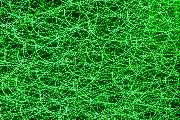 Background with green blurred magic neon light rays.