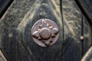 Rusty iron door knob on vintage wooden door