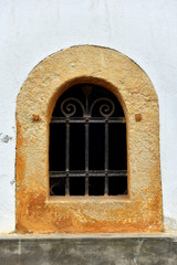 Fototapeta na wymiar Forged metal lattice on cellar window